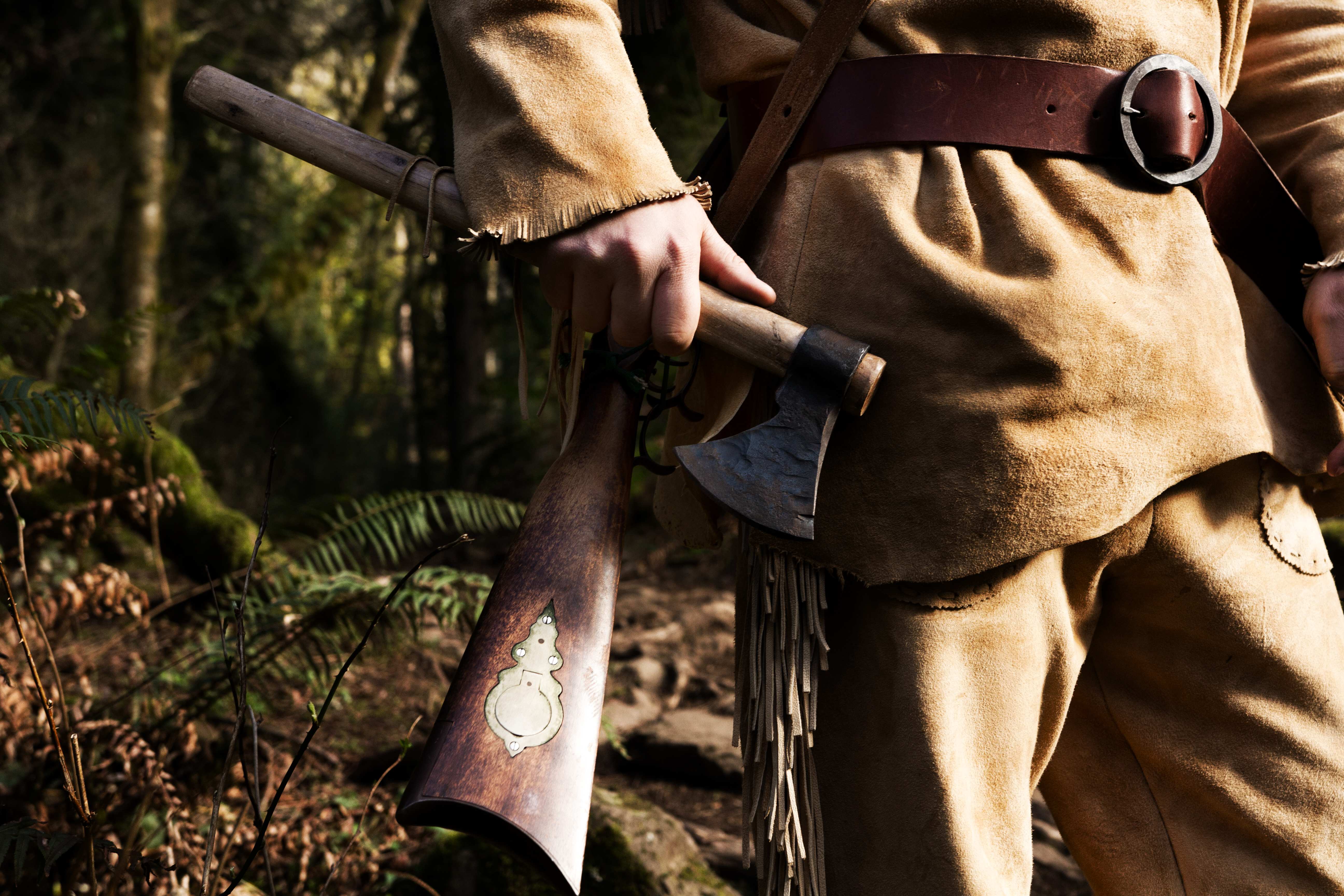 old trapper holding a hatchet
